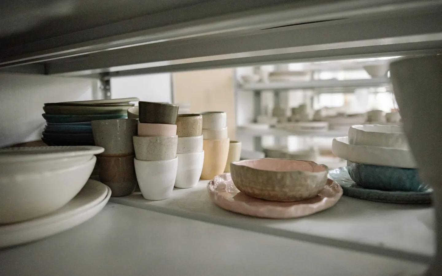 Ceramic tableware, bowls, and kitchenware arranged neatly for commercial product selection