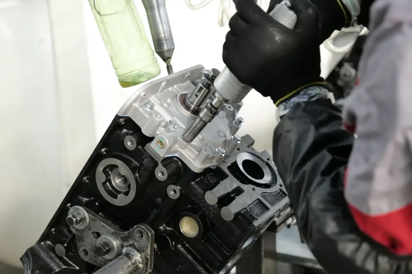 Technician assembling and inspecting precision mechanical engine components