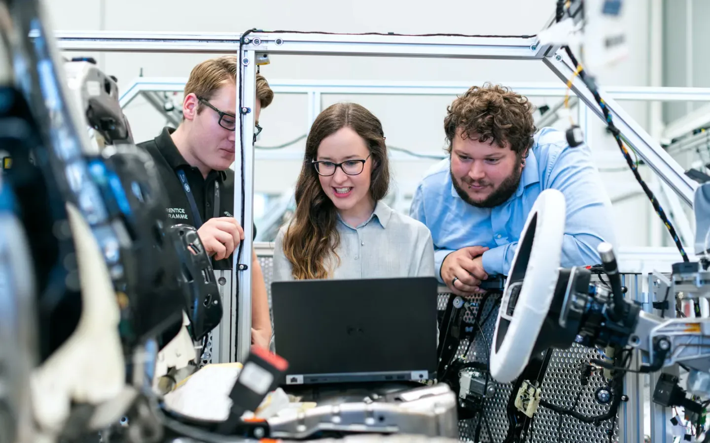 Engineers and buyers reviewing physical product samples and technical specifications together in a workshop